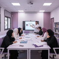 Premium educational classroom image, square format,
Arab students at an intermediate Hebrew level studying together,
female students on one side and male students on the other,
students participating in discussion and writing exercises,
young teacher guiding the class,
light lavender and soft purple color theme,
focused and confident academic atmosphere,
high-end education photography, no logos, no watermarks
girls with hijaab male teacher